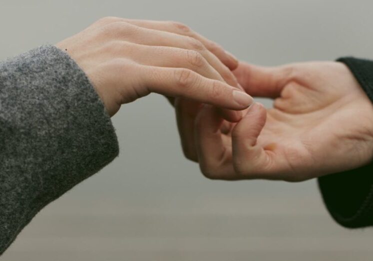 close-up-view-couple-holding-hands_cropped